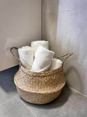 a basket filled with white towels in a bathroom at New One Bedroom Apartment with balcony in Kraków