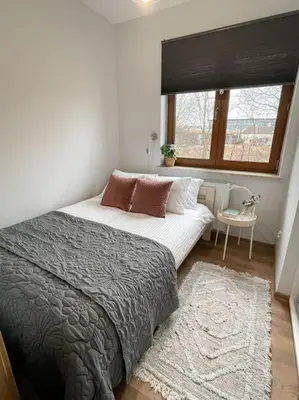 a bedroom with a large bed and a window at New One Bedroom Apartment with balcony in Kraków