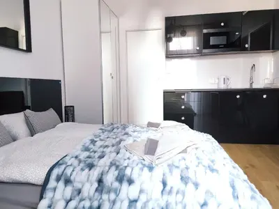 a bedroom with a bed with a book on it at Szeroka 33 A-C by Homeprime in Kraków