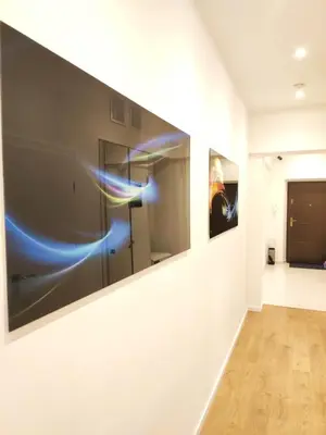 a hallway with two paintings on the wall at Szeroka 33 A-C by Homeprime in Kraków