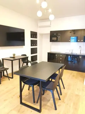 a kitchen and dining room with a table and chairs at Szeroka 33 A-C by Homeprime in Kraków