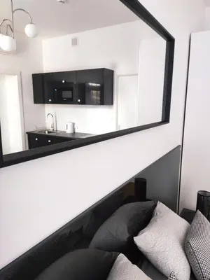 a mirror on the wall of a living room at Szeroka 33 A-C by Homeprime in Kraków