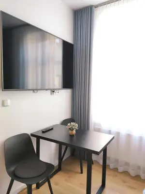 a black table and two chairs in a room at Szeroka 33 A-C by Homeprime in Kraków