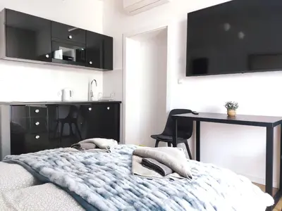a bedroom with a bed and a table in it at Szeroka 33 A-C by Homeprime in Kraków