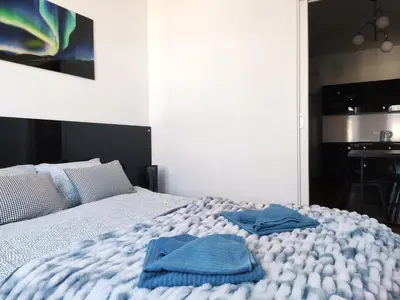 a bedroom with a bed with two towels on it at Szeroka 33 A-C by Homeprime in Kraków