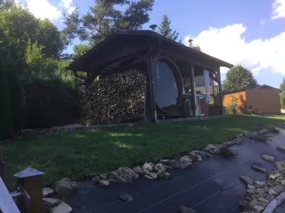a gazebo with a pile of firewood at Chata Panorama in Stróża
