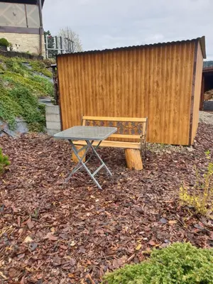 a picnic table and a bench in front of a fence at Chata Panorama in Stróża