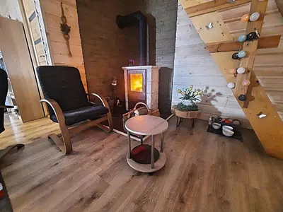 a room with a staircase and a chair and a table at Chata Panorama in Stróża