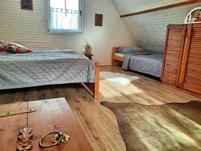 a attic bedroom with two beds and a window at Chata Panorama in Stróża