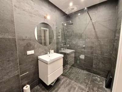 a bathroom with a sink and a shower at Apartament ulica Lema - Tauron Arena Kraków, parking, WiFi in Kraków