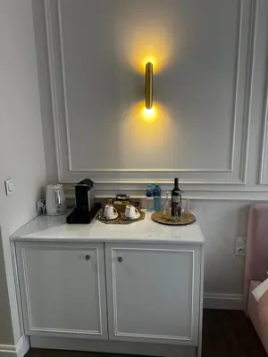a white counter with two sinks and a light at Apartament z Jacuzzi Kraków GLAMOUR Starowiślna in Kraków