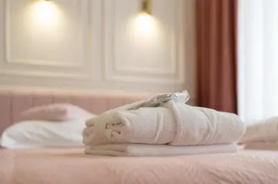 a pile of towels sitting on top of a bed at Apartament z Jacuzzi Kraków GLAMOUR Starowiślna in Kraków