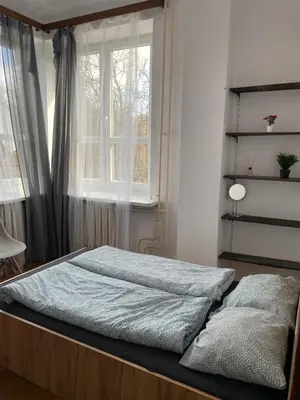 a bedroom with a large bed with a window at Classy Rooms in Old Town in Kraków