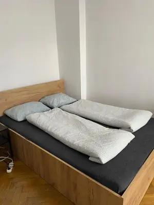 a bed with two pillows on top of it at Classy Rooms in Old Town in Kraków