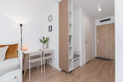 a small apartment with a desk and a bedroom at Saska Blu Studios Premium by Noclegi Renters in Kraków
