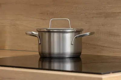 a metal pot sitting on top of a stove at Saska Blu Studios Premium by Noclegi Renters in Kraków