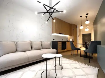 a living room with a white couch and a table at Lovely Apartment in Kraków