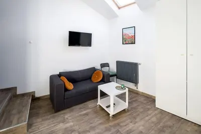 a living room with a couch and a table at Modern apartment in the very central location 20 in Kraków