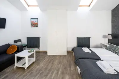 a bedroom with a large bed and a couch at Modern apartment in the very central location 20 in Kraków