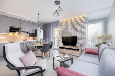 a living room with a couch and a dining room at Business Apartment for Home Office Kołaczy Kraków by Noclegi Renters in Kraków