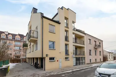 an apartment building in a parking lot at Business Apartment for Home Office Kołaczy Kraków by Noclegi Renters in Kraków