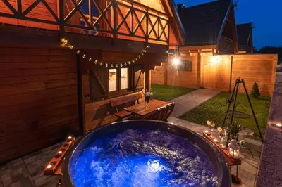 a large jacuzzi tub in the backyard of a house at Domki Gorczański Zakątek - Jacuzzi in Nowy Targ