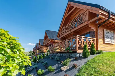 a wooden building with plants in front of it at Domki Gorczański Zakątek - Jacuzzi in Nowy Targ