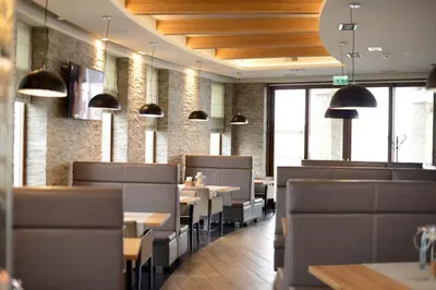 a dining room with tables and chairs in a restaurant at MOLO RESORT KEMPING in Osiek