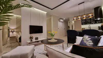 a living room with a couch and a table at Apartament Bulwary Oświęcim in Oświęcim