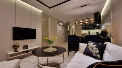 a living room with a white couch and a table at Apartament Bulwary Oświęcim in Oświęcim