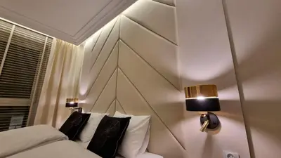 a bedroom with a bed with a wooden headboard at Apartament Bulwary Oświęcim in Oświęcim