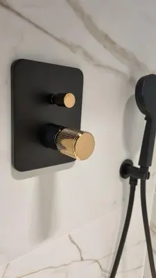 a black candle holder on a wall with two candles at Apartament Bulwary Oświęcim in Oświęcim