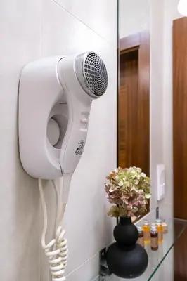 a hair dryer on a wall in a bathroom at Przytulnie i naturalnie — Balkon in Kraków