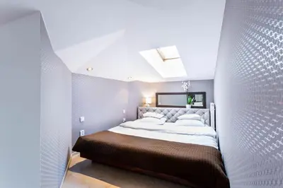a bedroom with a large bed in a room at Jacuzzi Kraków Bamboo in Kraków