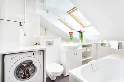 a white bathroom with a washing machine and a sink at Jacuzzi Kraków Bamboo in Kraków