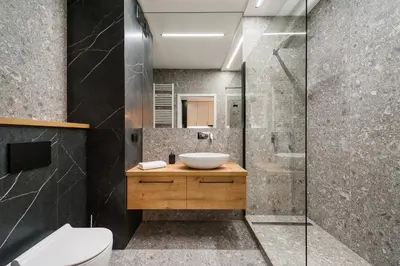 a bathroom with a sink and a shower at Krakowiak Apartment in Kraków