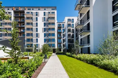 an image of an apartment building with a garden at Krakowiak Apartment in Kraków