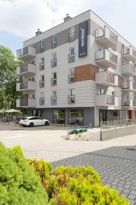 a building with a car parked in front of it at Aparthotel Weissa 7 in Kraków