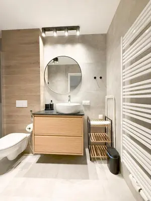 a bathroom with a sink and a mirror at Aparthotel Weissa 7 in Kraków