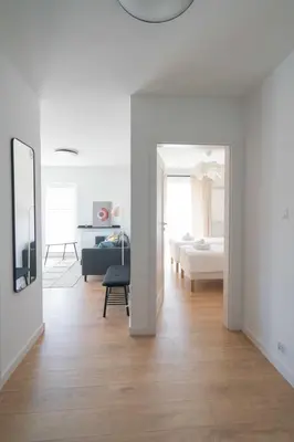 a hallway with a living room and a bedroom at Aparthotel Weissa 7 in Kraków