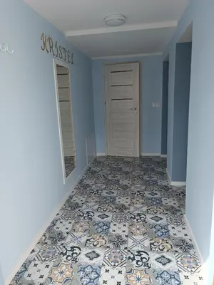 a hallway with a tile floor in a house at Apartament Kristel Zator in Podolsze