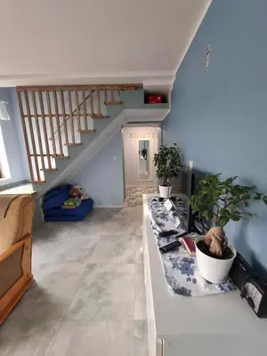 a living room with a staircase with potted plants at Apartament Kristel Zator in Podolsze
