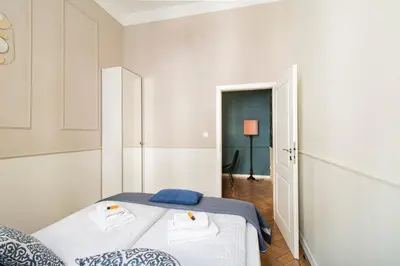 a bedroom with a bed with two towels on it at Modern Apartments Piłsudskiego Street in Kraków