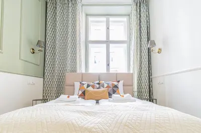a bedroom with a large bed with a window at Modern Apartments Piłsudskiego Street in Kraków