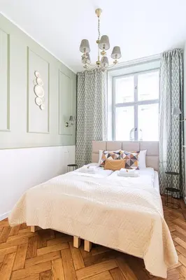 a bedroom with a large bed and a window at Modern Apartments Piłsudskiego Street in Kraków