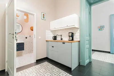 a kitchen with white cabinets and a counter top at Modern Apartments Piłsudskiego Street in Kraków