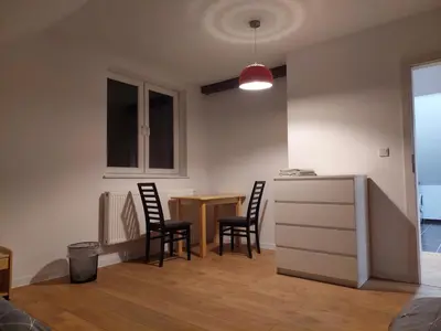 a kitchen and dining room with a table and chairs at Pokoje Kraków Tyniec Hostel in Kraków
