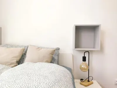 a bedroom with a bed and a tv on the wall at Mogilska 120D by Homeprime in Kraków