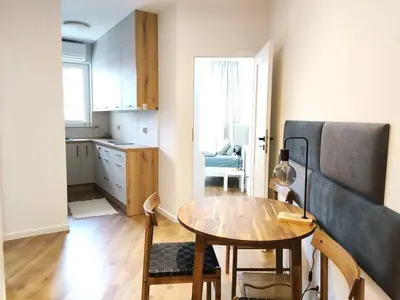 a small kitchen with a table and a dining room at Mogilska 120D by Homeprime in Kraków