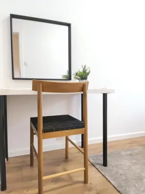 a desk with a chair in front of a mirror at Mogilska 120D by Homeprime in Kraków